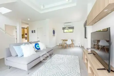 Spacious modern living room with stylish decor and open layout, perfect for relaxation and entertainment.