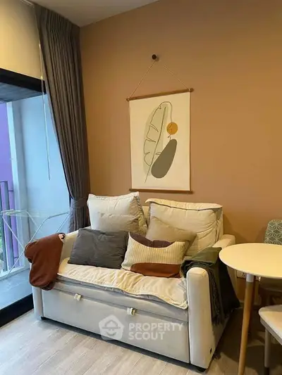 Cozy living room with modern decor and balcony access, ideal for relaxation and comfort.