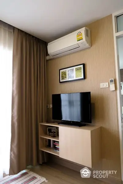 Modern living room with wall-mounted TV and air conditioning unit