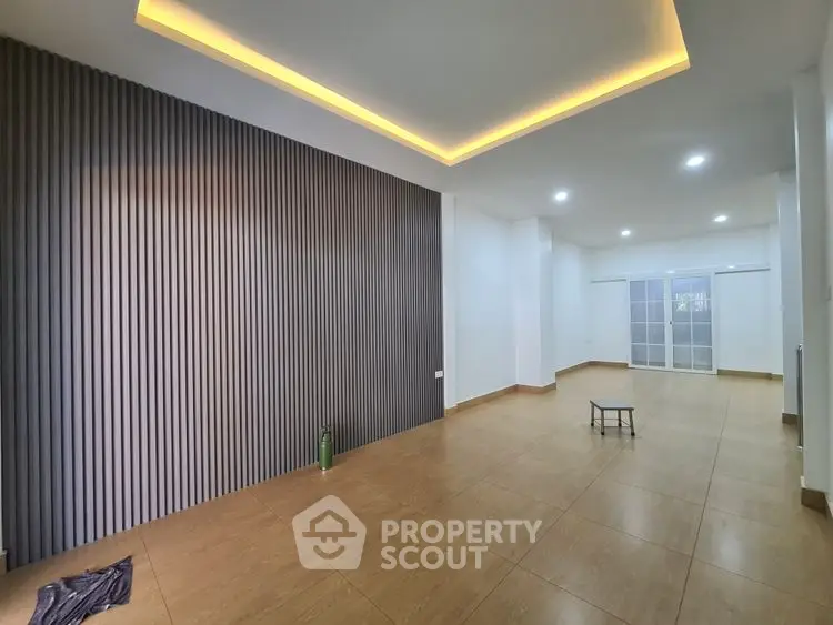 Spacious modern living room with stylish lighting and wooden flooring