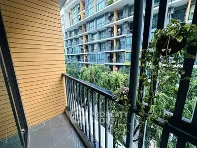 Charming balcony with lush green view in modern apartment complex