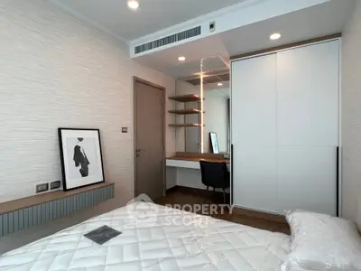 Modern bedroom with stylish decor and built-in wardrobe in a contemporary apartment.