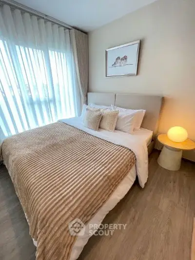 Cozy bedroom with elegant decor and soft lighting, featuring a plush bed and stylish side table.