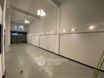 Spacious commercial space with high ceilings and modern lighting, ideal for retail or office use.