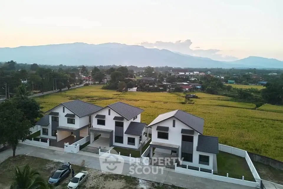 Stunning aerial view of modern homes with mountain backdrop, perfect for serene living.