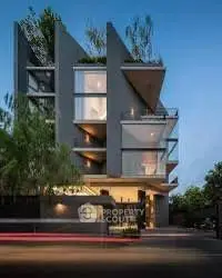 Modern architectural building with unique geometric design and lush greenery