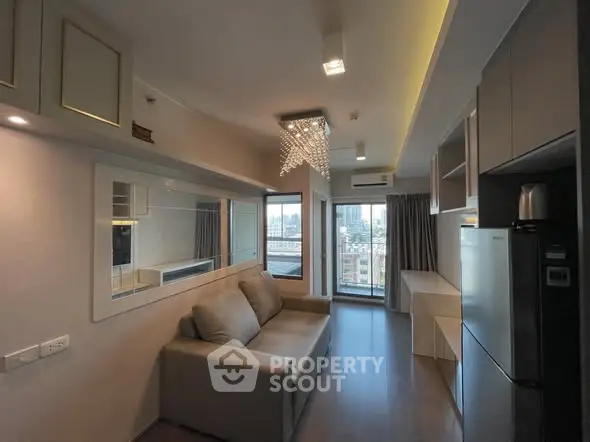 Modern living room with city view, stylish lighting, and sleek furnishings in a high-rise apartment.