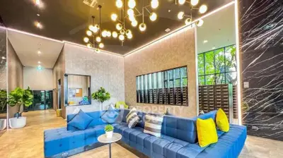 Luxurious modern lobby with stylish seating and elegant lighting in upscale building.