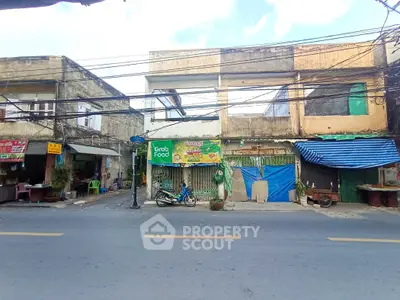 Street view of commercial buildings with potential for renovation and business opportunities.