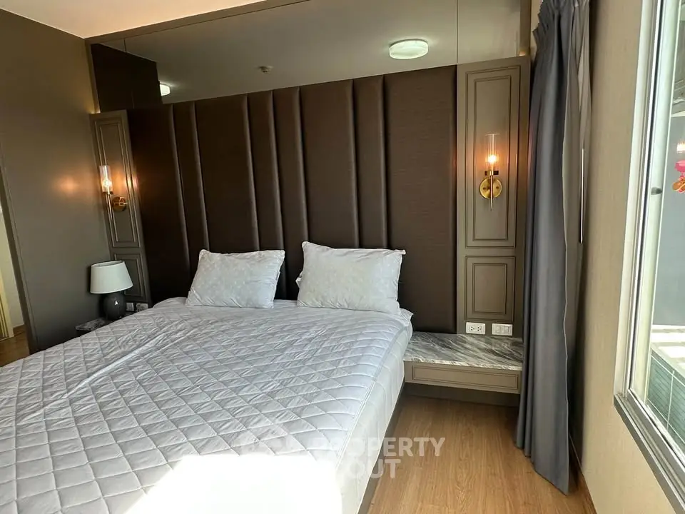 Luxurious bedroom with elegant decor and large window for natural light