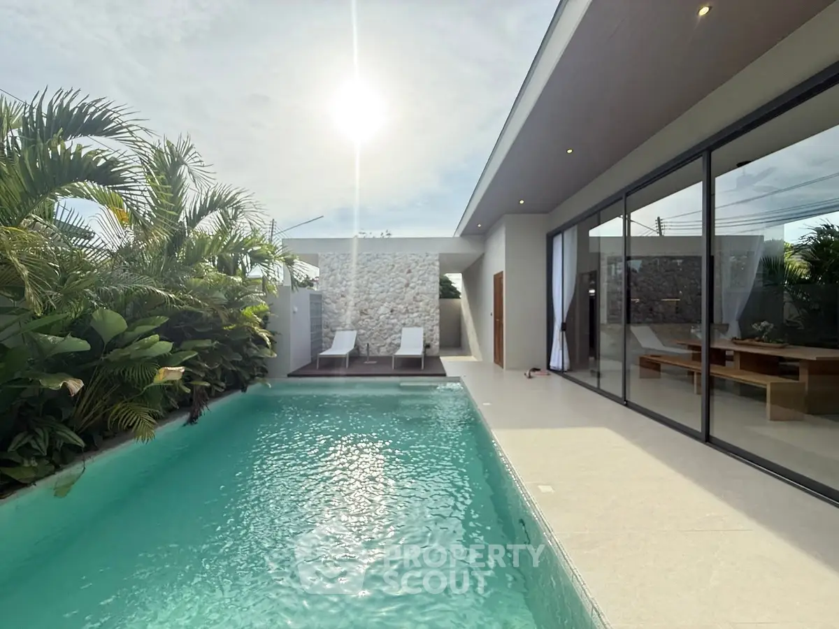 Luxurious modern villa with private pool and lush greenery, perfect for relaxation and entertaining.
