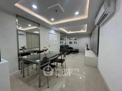 Modern living room with sleek dining area and stylish lighting