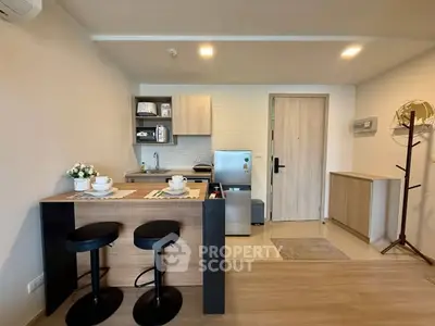Modern kitchen with open layout and stylish breakfast bar in a cozy apartment.