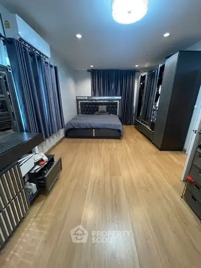 Spacious modern bedroom with elegant decor and ample storage space