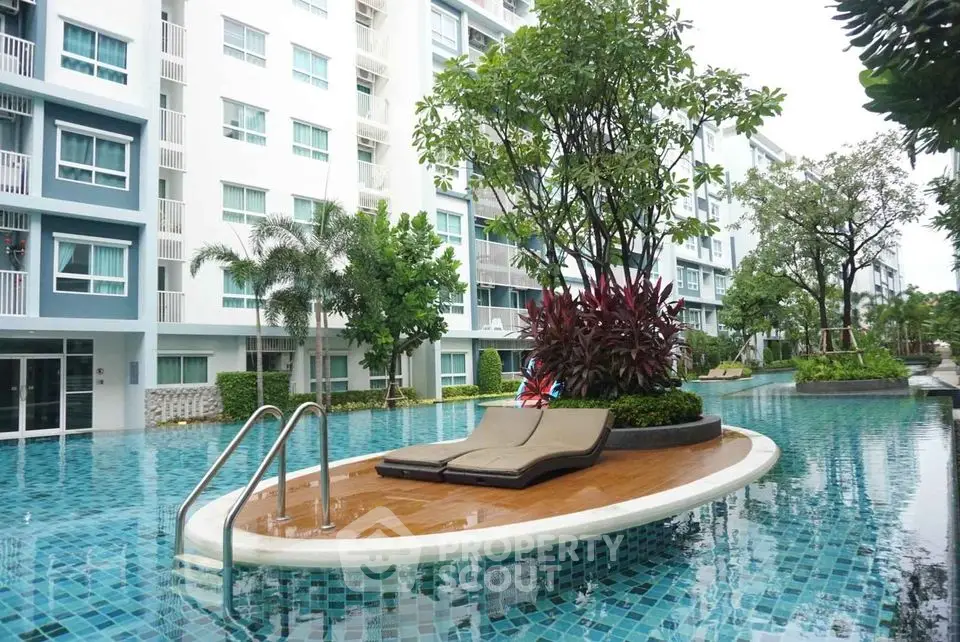 Luxurious apartment complex with stunning pool and lush greenery
