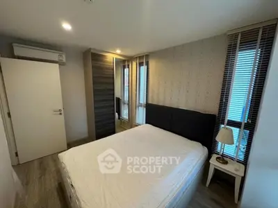 Modern bedroom with stylish decor and ample natural light