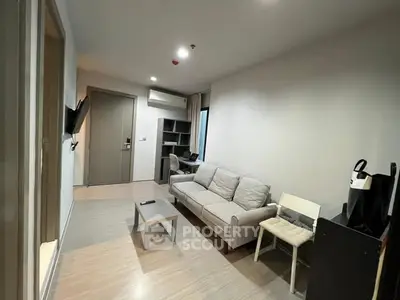 Modern living room with cozy sofa and wall-mounted TV in a stylish apartment.