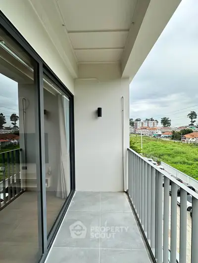 Modern balcony with sleek railing and scenic view, perfect for relaxation and enjoying the outdoors.