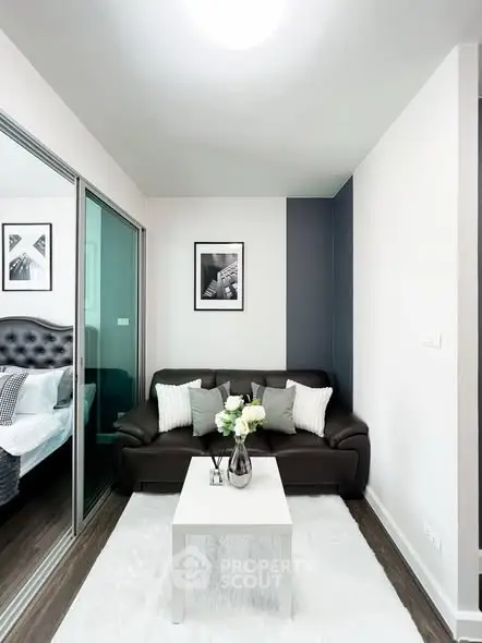 Modern living room with sleek black sofa and stylish decor