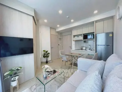 Modern open-plan living room with sleek kitchen and cozy seating area