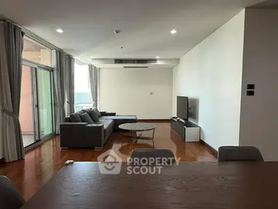 Spacious living room with modern furniture and large windows for natural light.