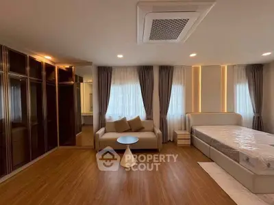 Spacious bedroom with modern design and cozy seating area
