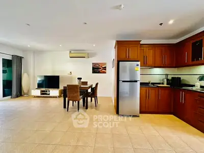 Spacious open-plan living room and kitchen with modern appliances and elegant dining area.