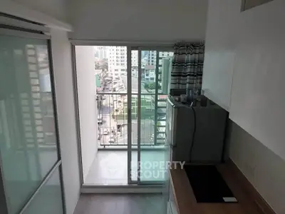 Modern kitchen with balcony view in urban apartment