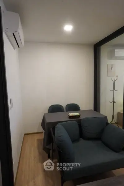 Cozy living room with modern furniture and air conditioning, perfect for relaxation and entertaining.