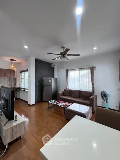 Spacious living room with modern decor and open kitchen layout