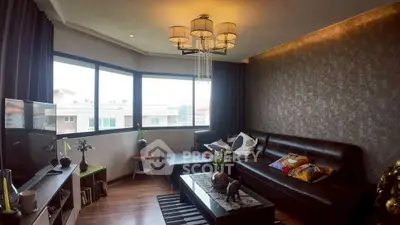 Stylish living room with modern decor and large windows offering natural light.