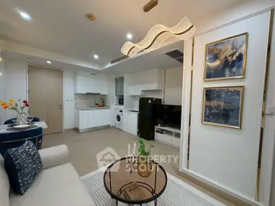 Modern open-layout living room with stylish decor and integrated kitchen appliances