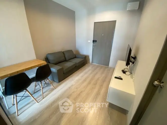 Modern compact living room with sleek furniture and wooden flooring