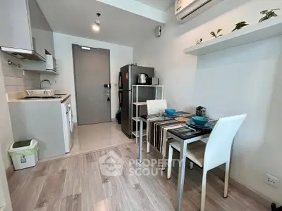 Modern compact kitchen and dining area with sleek appliances and stylish decor.