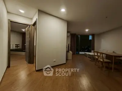 Spacious modern living room with wooden flooring and city view