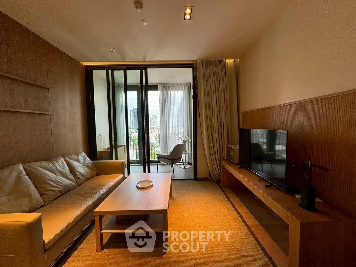 Modern living room with cozy sofa, TV, and balcony view in stylish apartment.