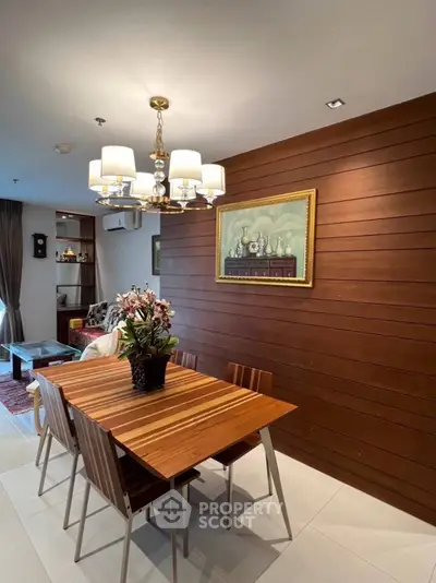 Elegant dining area with wooden accents and modern chandelier in a cozy apartment.