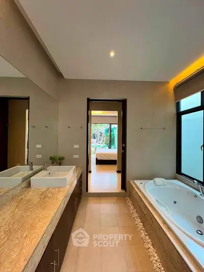 Luxurious bathroom with double sinks and jacuzzi tub in modern home