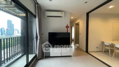 Modern living room with balcony view in high-rise apartment, featuring sleek design and natural light.