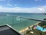 Stunning ocean view from a modern balcony overlooking the beach and city skyline.