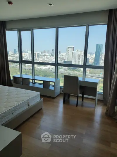Spacious bedroom with stunning city view and modern furnishings