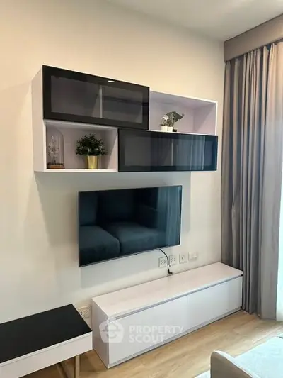 Modern living room with sleek wall-mounted TV and stylish storage units.