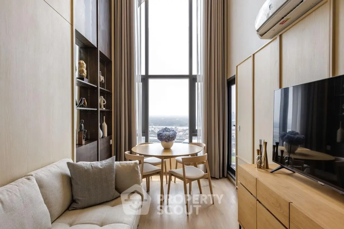 Modern living room with high ceilings and panoramic window view