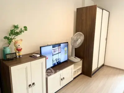 Cozy living room with modern TV stand, wardrobe, and decorative elements.