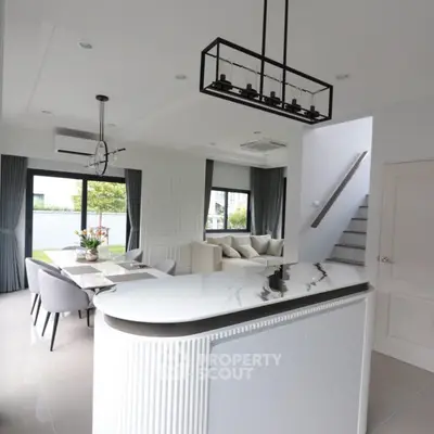 Modern open-plan living room with elegant kitchen island and stylish decor