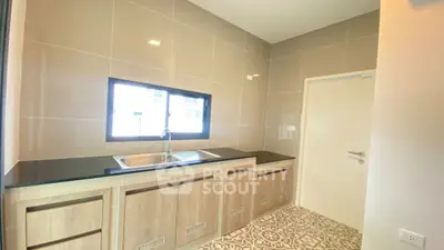Modern kitchen with sleek cabinetry and stylish tile flooring