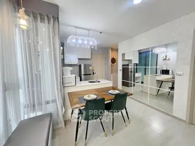 Modern kitchen with dining area and stylish lighting in a contemporary apartment.