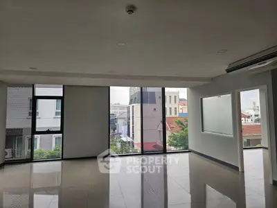 Spacious modern living room with large windows and city view