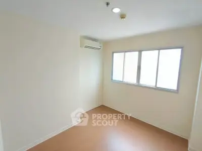 Bright empty room with air conditioning and large window, perfect for customization.