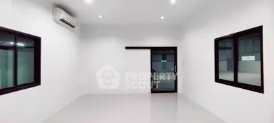 Spacious modern room with large windows and air conditioning